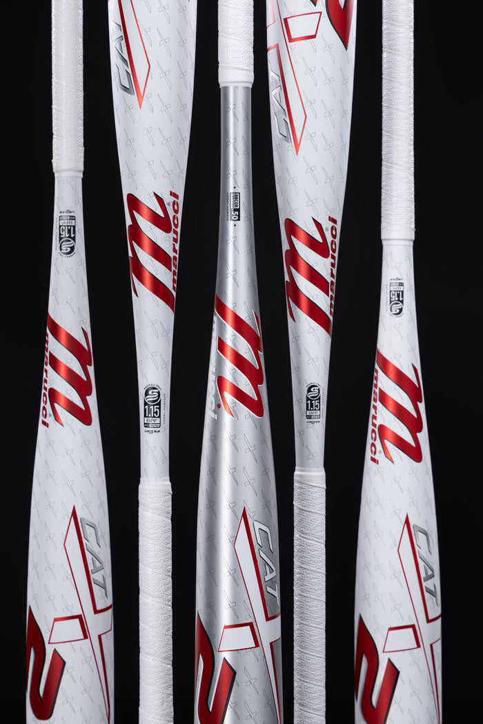 Five white and silver 2025 Marucci CATX2 (-10) 2 3/4" USSSA Baseball Bats with red m logos and CAT branding, each featuring white grip tape, are displayed vertically against a black background.
