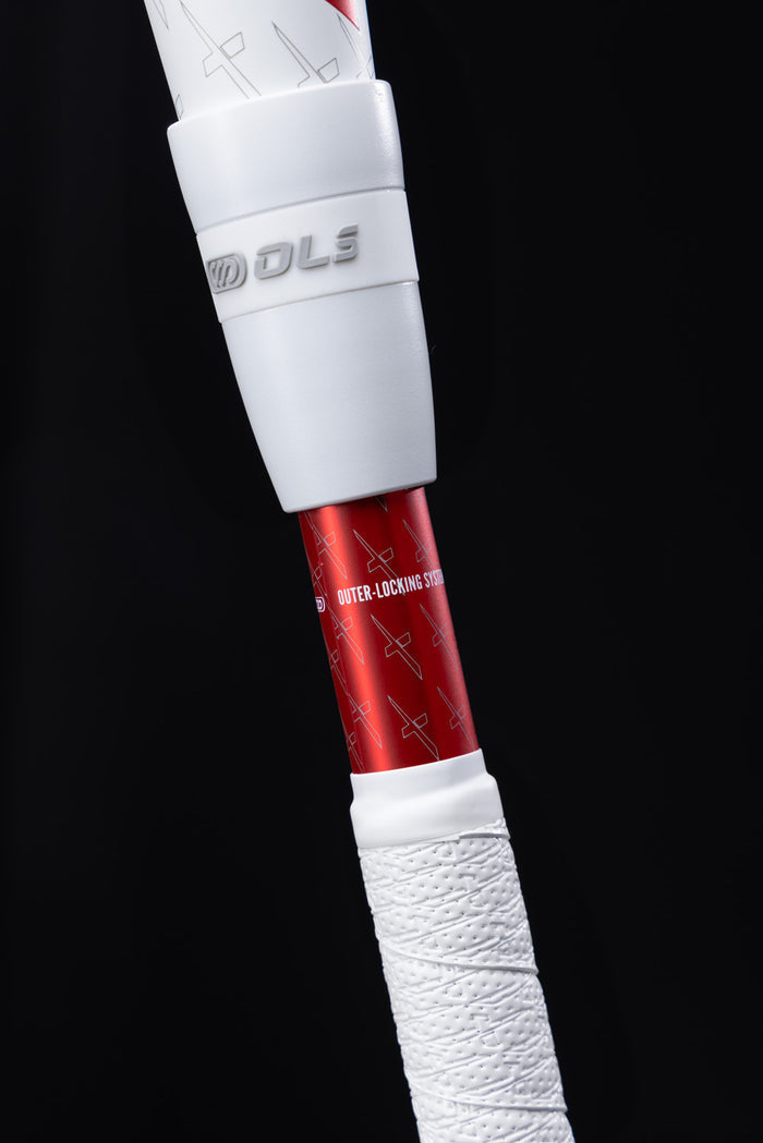Close-up of a Marucci 2025 CATX2 Connect (-10) USSSA Baseball Bat handle showing white grip tape, a white plastic guard, and Outer-Locking System text on the red shaft with anti-vibration technology against a black background.