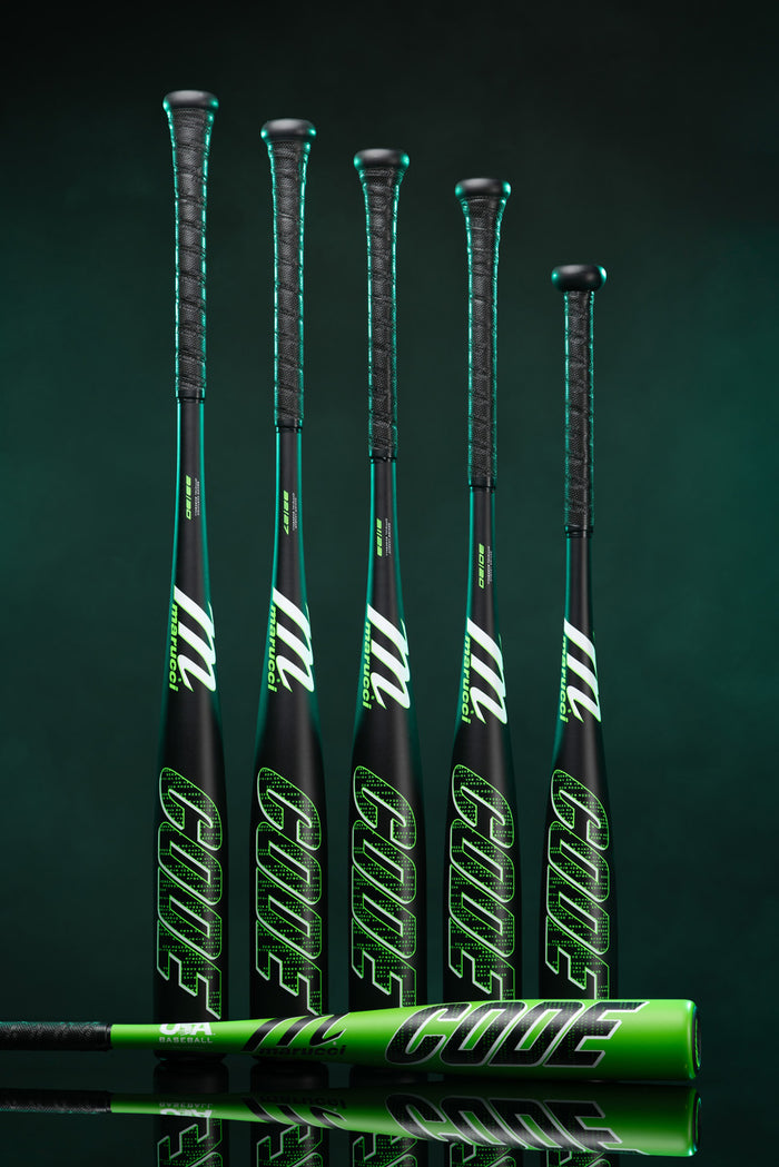 Six Marucci 2025 Code (-5) USSSA Baseball Bats, crafted with AZ75 Alloy, stand upright with one bat horizontal. "CODE" is displayed in green on each bat, set against a dark, smoky green background.