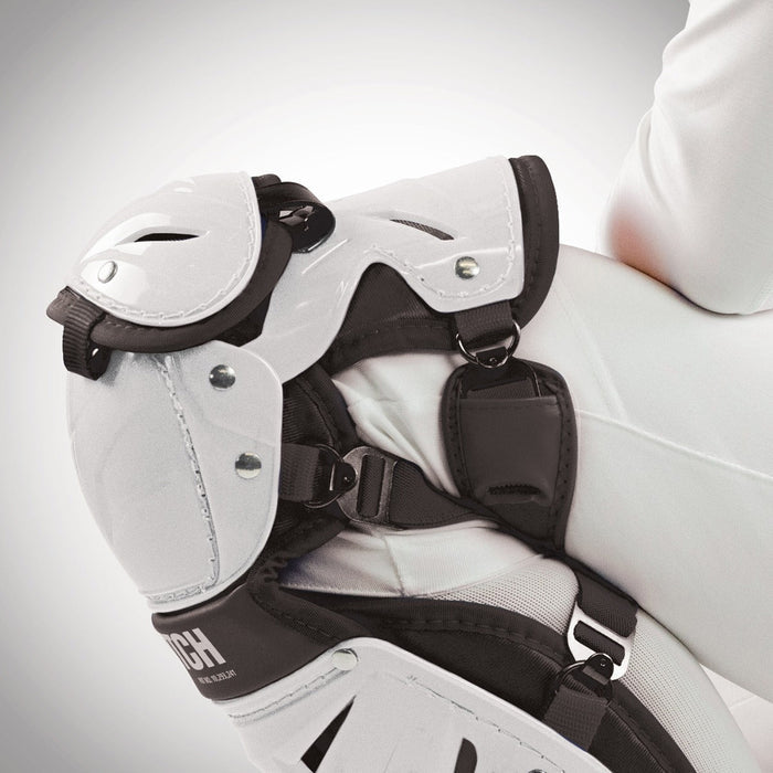 A close-up of a person wearing All Star AFx Fastpitch Catcher's Leg Guards: LGW-AFX, focusing on the knee and upper leg with securely fastened pads and straps, showcasing advanced women’s protection from All Star.