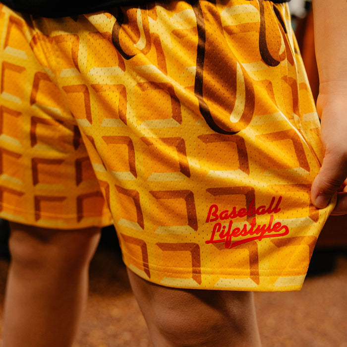 Waffle themed shorts and 'Baseball Lifestyle' logo worn by a person.