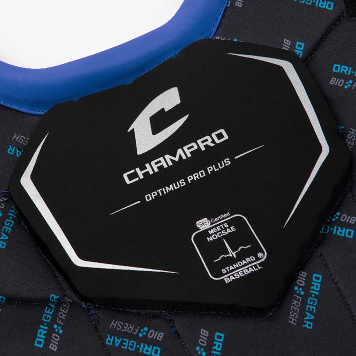Close-up of a black Champro Sports Optimus Pro Plus Catcher's Chest Protector (CPN1), displaying the brand logo, NOCSAE certification details, and resting on quilted fabric labeled “DRI-GEAR BIO-FRESH” in blue.