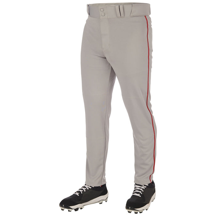 A person wears Champro Sports Adult Triple Crown 2.0 Tapered Baseball Pants with red piping (BP66) and black cleats, shown from the waist down against a white background.