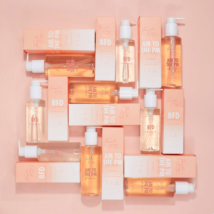 Come Clean Cleansing Duo featuring Fourth Ray Beauty AM to the PM gel cleanser and BFD cleansing oil, pump bottles and peach-and-white boxes arranged in a flat lay on a pastel peach background, a ColourPop Face Cleanser set.
