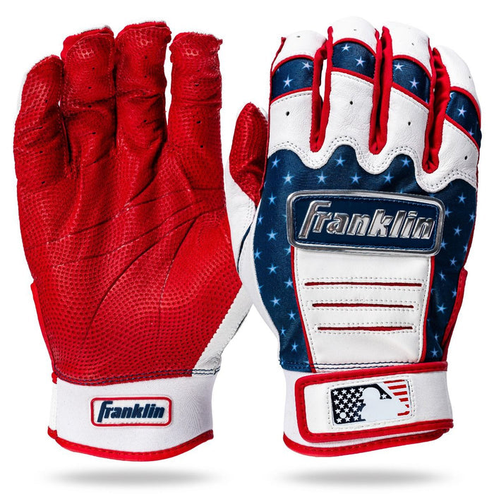 Franklin CFX Pro Fourth of July Limited Edition Batting Gloves: one solid red, the other features American flag stars and stripes. Both display Franklin and MLB logos at the wrist.
