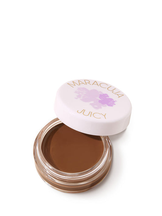 Open jar of brown cream with 'Maracluca' lid on a white background
