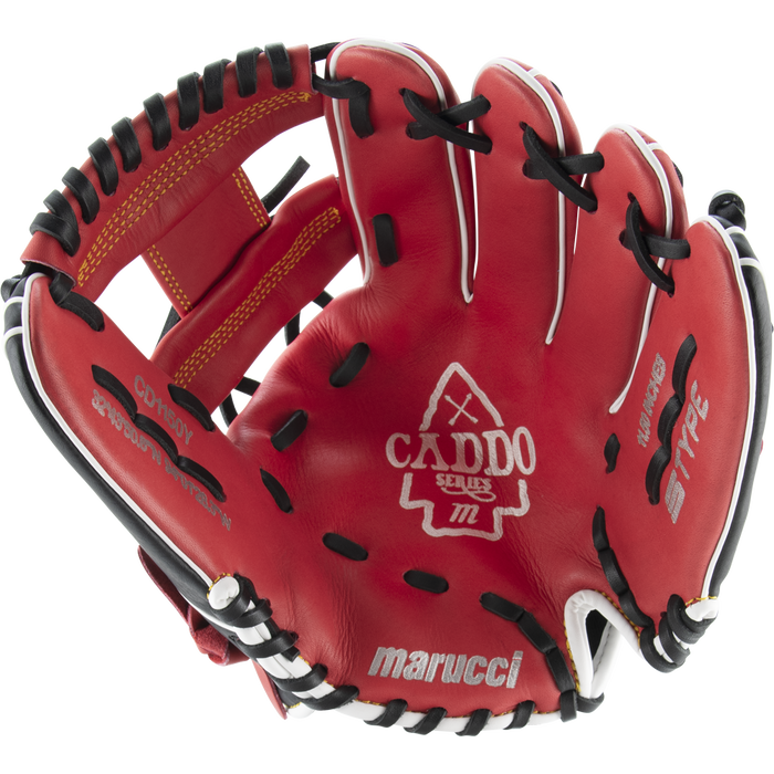 The Marucci Caddo 11.5" Baseball Glove (MFG2CD1150) features red leather with black and white accents, visible stitching, embossed Marucci branding on the palm, an open design showing its interior, finger slots, and adjustable fit.