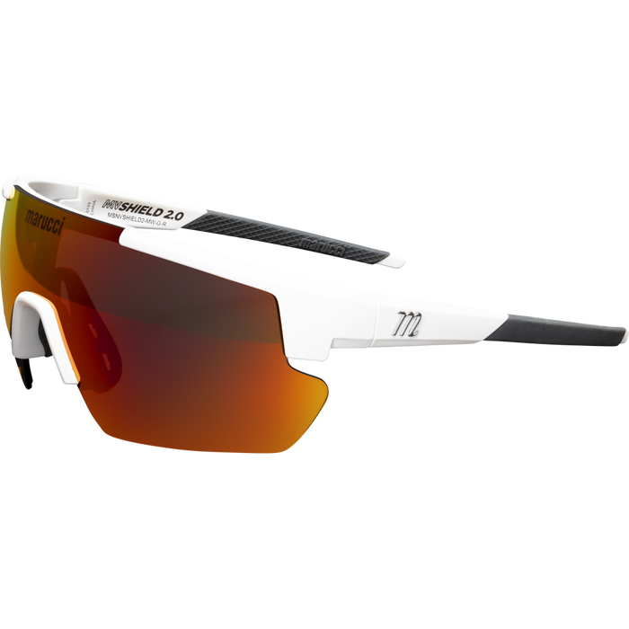 The Marucci Shield 2.0 Performance Sunglasses (MSNVSHIELD2) feature a white frame, single oversized red-orange mirrored lens, black arm accents, and visible Marucci branding—perfect on-field sunglasses for athletes.