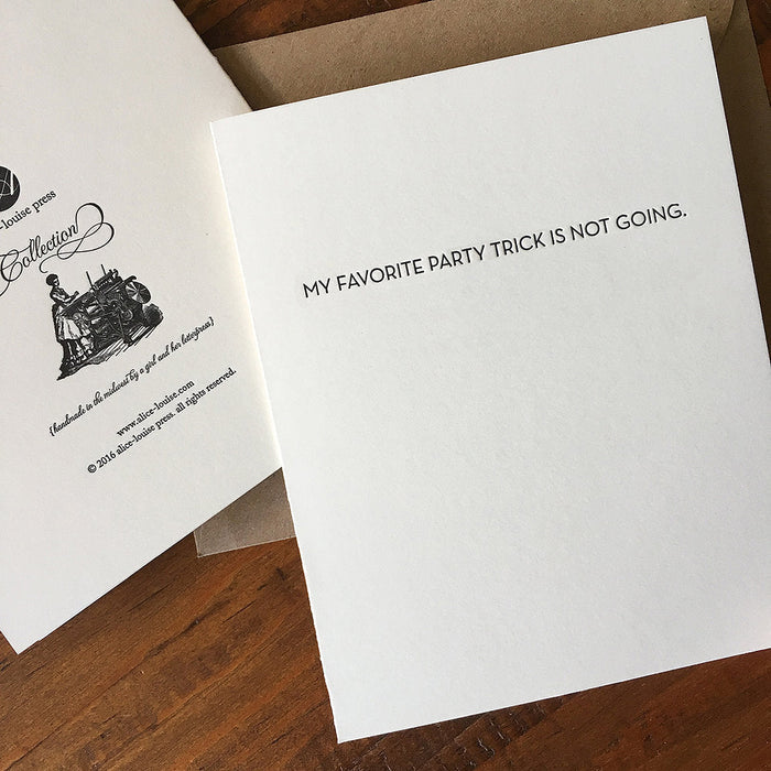 White greeting card with black text: "MY FAVORITE PARTY TRICK IS NOT GOING."