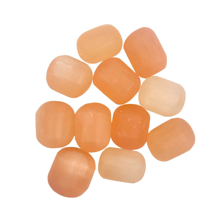 Peach Selenite Tumble pieces arranged in a circular pattern on a white background