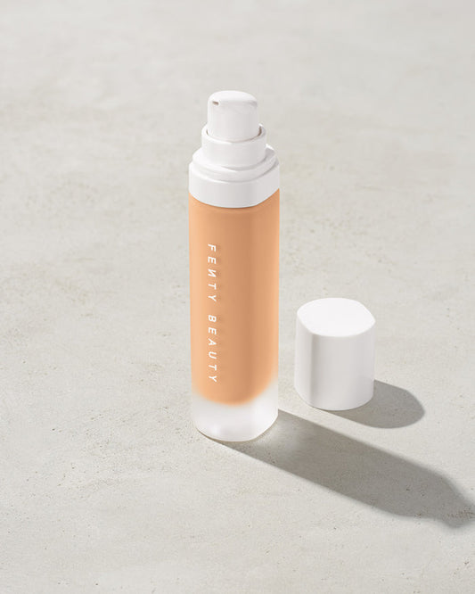 open bottle of Fenty Beauty Pro Filt'r Soft Matte Longwear Foundation with pump dispenser in shade #230 on concrete background