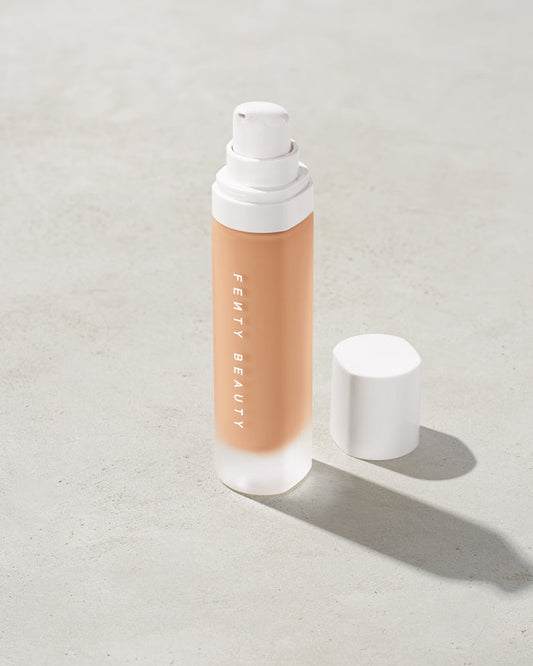 open bottle of Fenty Beauty Pro Filt'r Soft Matte Longwear Foundation with pump dispenser in shade #260 on concrete background