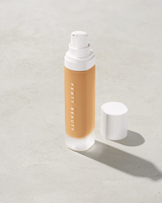 open bottle of Fenty Beauty Pro Filt'r Soft Matte Longwear Foundation with pump dispenser in shade #290 on concrete background