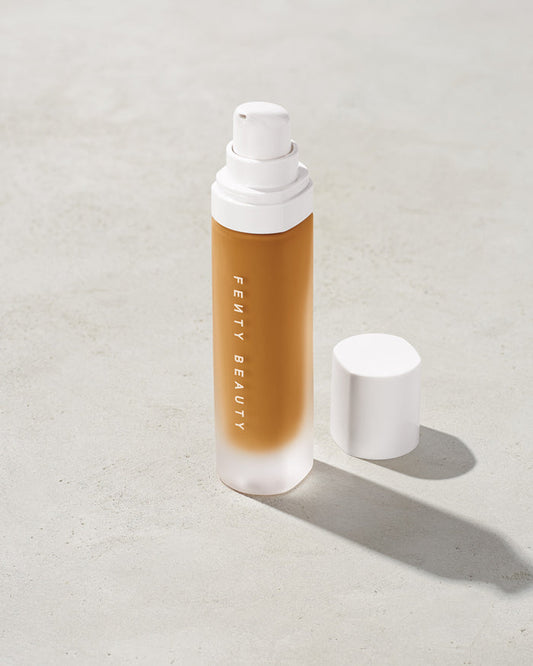 open bottle of Fenty Beauty Pro Filt'r Soft Matte Longwear Foundation with pump dispenser in shade 350 on concrete background