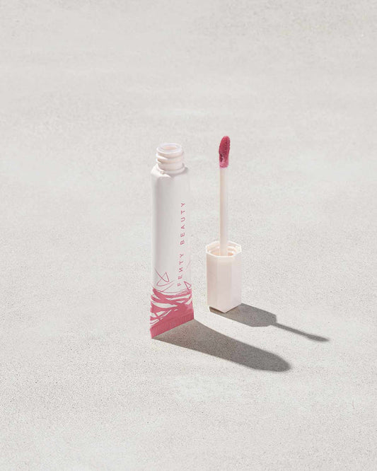 Open tube of Pro Kiss'r Luscious Lip Balm in shade Pinch Me on grey background.