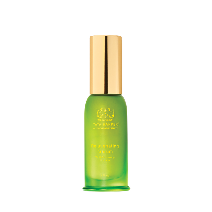A green glass bottle with a gold cap containing the Tata Harper Rejuvenating Serum (30 ml).