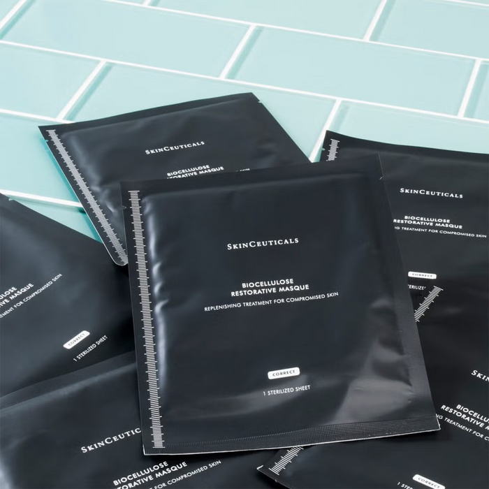 Skinceuticals Biocellulose Restorative Mask packets on a light blue tile background