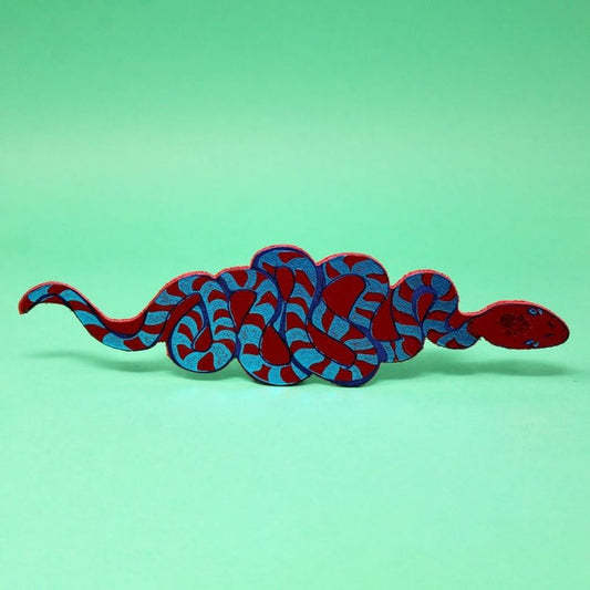 Snake bookmark with dark red scales and blue pattern, curled body
