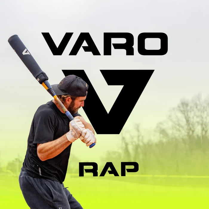 A baseball player in black swings a bat fitted with the Varo RAP Weighted Hittable Training Sleeve. The text "Varo RAP" and a large V logo appear in the background, outdoors amid trees and a cloudy sky.