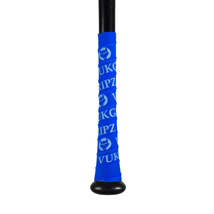 A close-up of the VukGripz Bat Grip Tape by VukGripz shows its bright blue handle wrap featuring white text, logo patterns, and a stylized animal face, all designed for optimum grip.