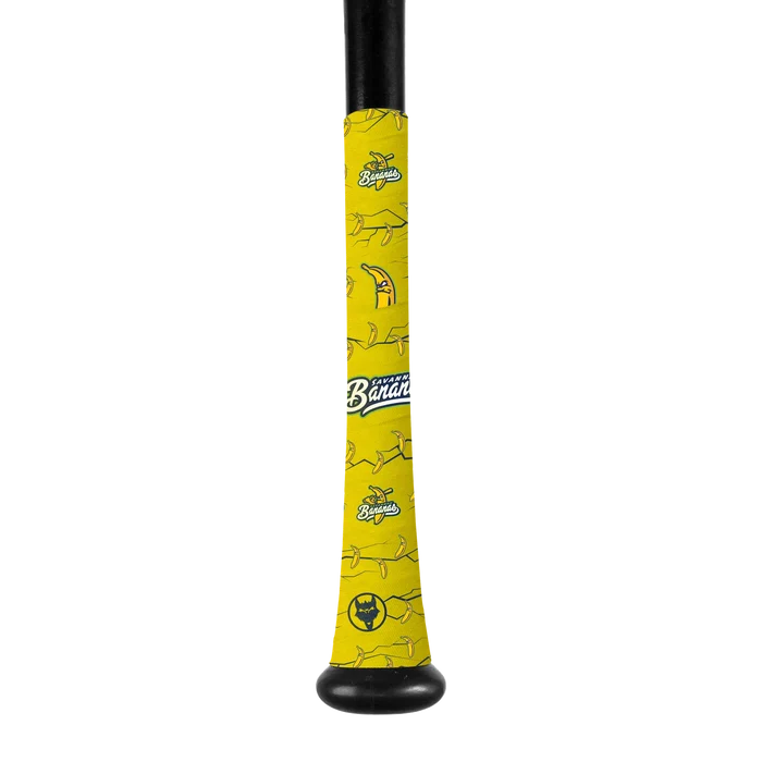 A VukGripz Bat Grip Tape by VukGripz, wrapped on a baseball bat handle, features bright yellow color with cartoon bananas and the Savannah Bananas logo for optimal grip, displayed against a plain white background.